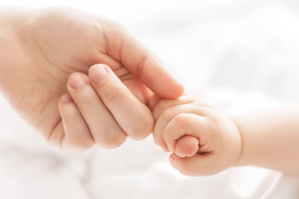 Hand of the child in a hand of mother